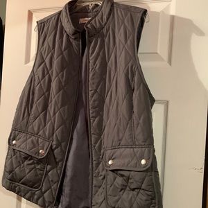 vest with drawstring back to tighten with silver buttons on front and zipper